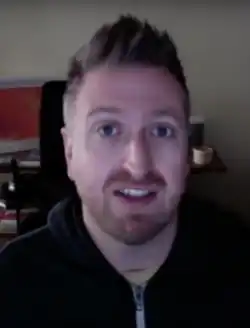 Casey Newton speaks in a black hoodie