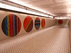 An empty hallway. On the walls and floors are mosaic circles