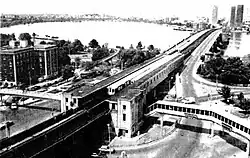An aerial view of an elevated railway station with footbridges on either side