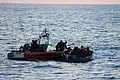 A Robert Yered small boat crew gives life jackets to 50 Haitian migrants approximately 46 miles north of Cap Haïtien, Haiti, May 20, 2019.[13]