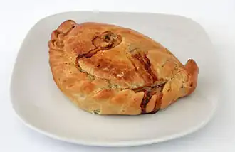 A light brown pastry case is on a white plate