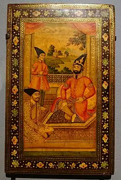 Photograph of an illustration, on the right is a bearded man, on the bottom left is a seated man, on the top left is a standing man, all wearing long caps and robes