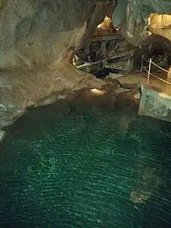 A blue lake with rippling waters inside the cave.