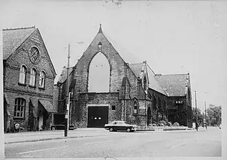 Black and white photo of a church on a street