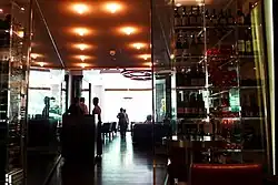 A long corridor with wine bottles on both sides.