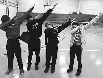 A group of teens dabbing, a popular fad and gesture of the youth around 2015–2016. Dabbing was the most prominent dance trend of the 2010s, which joined such dances as Flossing and the Harlem Shake.