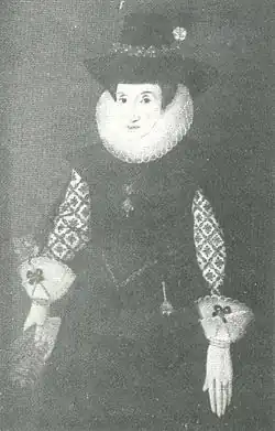 Formal portrait of Dorothy Davenport. She wears a dress of plain dark cloth with richly embroidered undersleeves, a ruff and frilled cuffs. On her head is a high-crowned felt hat trimmed with a flower.