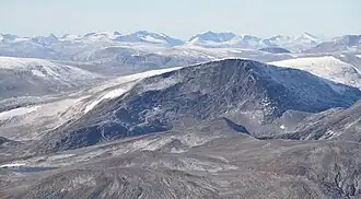 Barren mountains partially covered in snow