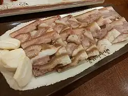 Dwaeji-meori-pyeonyuk (pressed boiled pork head slices) served with garlic