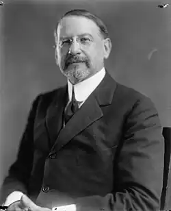 Photo of a man wearing a high-collar and pince-nez glasses