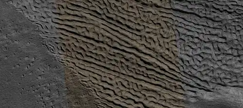 Close view of lineated valley fill (LVF) in valley, as seen by HiRISE under HiWish program. Linear valley flow is ice covered by debris. Lineated valley fill is generally considered to be and example of a glacier, as it involves the movement of ice.