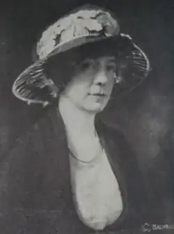 A white woman wearing a large brimmed hat