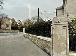 Boundary wall and gate pier with Greek patterns