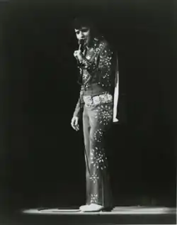 Photograph of Presley singing into a microphone