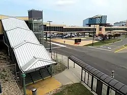 Staircase covered by canopy, with a footbridge behind