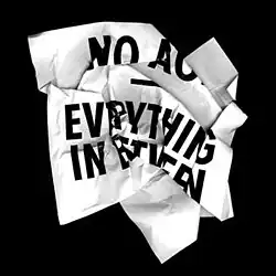 A crumbled piece of paper against a black background