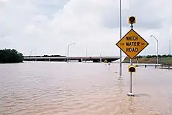 A "Watch for Water on Road" sign in the United States