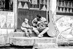 Guitarist Simphiwe Sekhute plays music with his son in South Africa, 2013.
