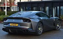 Rear 3/4 view showing quad tail lights and body-colored diffuser