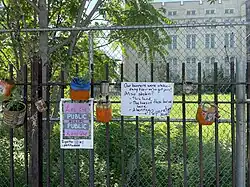 Signs and planters at the Flatbush African Burial Ground site, 2021
