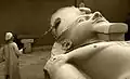 Museum worker in the process of cleaning the Ramesses II colossus