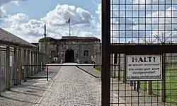 View of a fort in the distance with a chain-link fence to the left