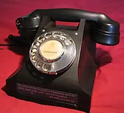 332 Telephone from the Director ENTerprise exchange which was in New Southgate, London. This telephone was manufactured in 1946 and factory refurbished in 1963 at the GPO Factory, Cwmcarn, Wales shown by F.W.R. on the base. A label attached indicates that the exchange had just converted to all figure dialling as opposed the letters and numbers as indicated by the dial label.