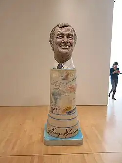 Bust of George Moscone on a pedestal with graffiti