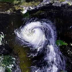 Satellite image of a hurricane over Cuba. The storm features well-defined feeder bands rotating around a weakened circulation. Florida can be seen at the top of the image and part of Honduras and Nicaragua are in the bottom left.