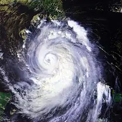 A large hurricane with a well-defined eye in the Gulf of Mexico. Cuba is mostly obscured; Florida can be seen in the top of the image; the Yucatán Peninsula is in the bottom left.