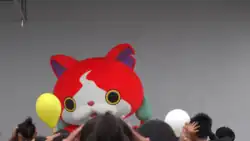 A costumed performer as the Yo-kai Watch character Jibanyan, performing in front of a crowd of kids