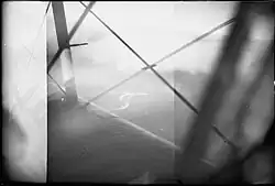 Black and white aerial photo of a ship taken from a long distance