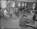 Gila River Relocation Center, Rivers, Arizona. A general view in the recreation hall of a group of evacuees playing "Go".