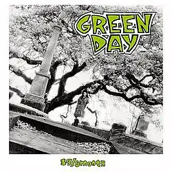 A black-and-white image of a woman standing in a graveyard with a tree behind her