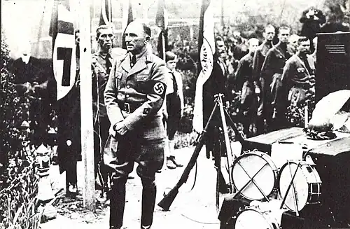 A man in a Nazi uniform indicating rank
