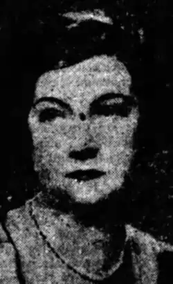 A newspaper photograph of a white woman with dark hair
