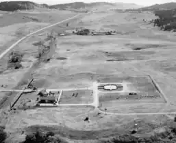 1959, looking south; aerial view showing only the entrance buildings and first sections completed