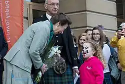 Princess Anne speaking to a girl while on a public engagement