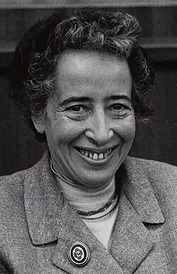 Black-and-white photo of a smiling woman with curly hair