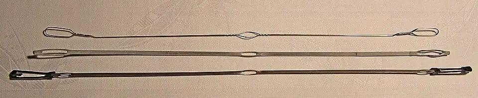 A variety of metal healds, made from wire and straps