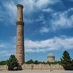 The remains of the madrase today: minaret No. 5, and the Gawhar Shad Mausoleum