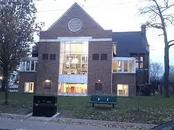 Two storey building of triangular shape around an entrance archway