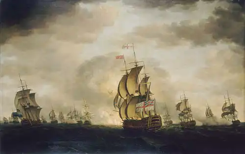 An oil painting depicting a sea battle. The sky has dark clouds with patches of blue, and the sea is grey. Warships are visible in the distance, some of which are exchanging cannon fire. A British warship occupies the centre foreground, obscuring an explosion behind it.