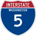 Highway marker for Interstate 5, comprising a blue shield with a red, three-pointed crown