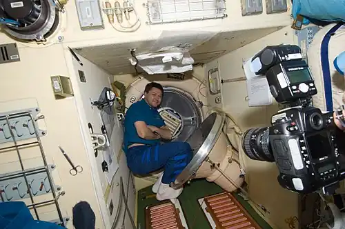 Oleg Kononenko is pictured near a hatch in the Pirs Docking Compartment.