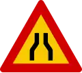 Road narrows on both sides