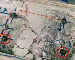 A damaged concrete slab showing incorrect distances concerning stud placement.
