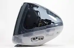 Side view of an iMac in a translucent gray and white color scheme.