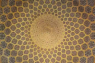 The interior of the dome which is inset with a network of lemon-shaped compartments, which increase in size as they descend from a formalised peacock at the pattern inlaid on plain stucco