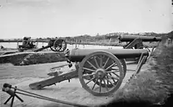 Two Model 1829 32-pounder siege and garrison guns, rifled by the James method (64-pdr James rifles). The one in the foreground is on a siege carriage. The one behind is on an iron, front pintle, barbette carriage.